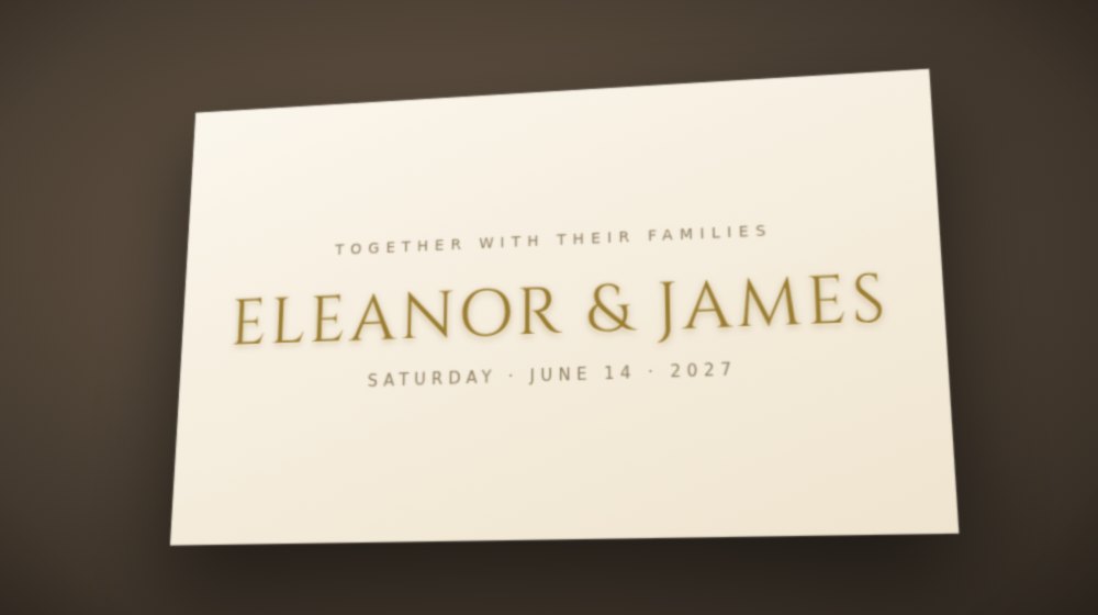 Photo of a cream wedding invitation at an angle with ELEANOR and JAMES in gold Roman capitals